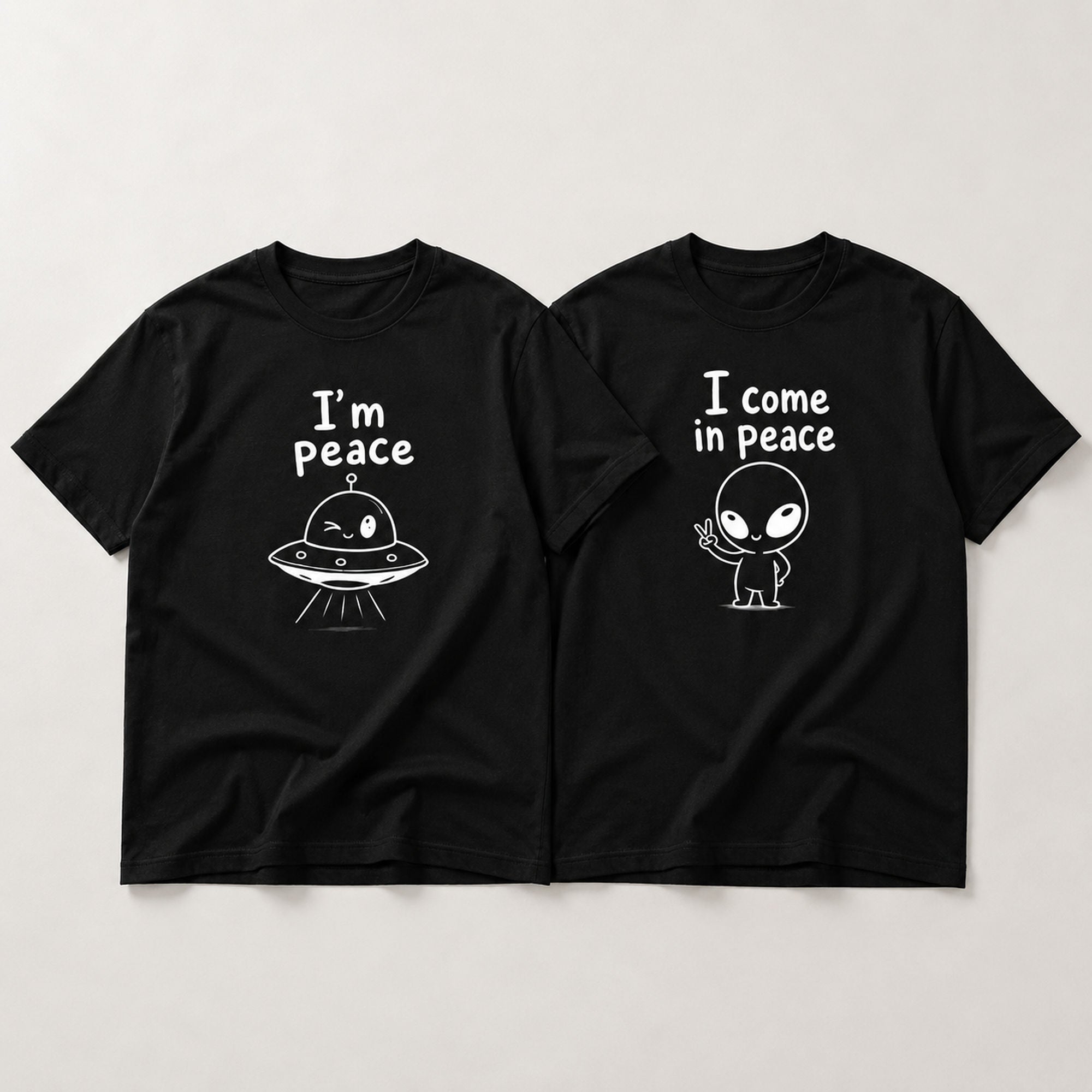 I Come In Peace matching couple alien graphic tee black front flat lay