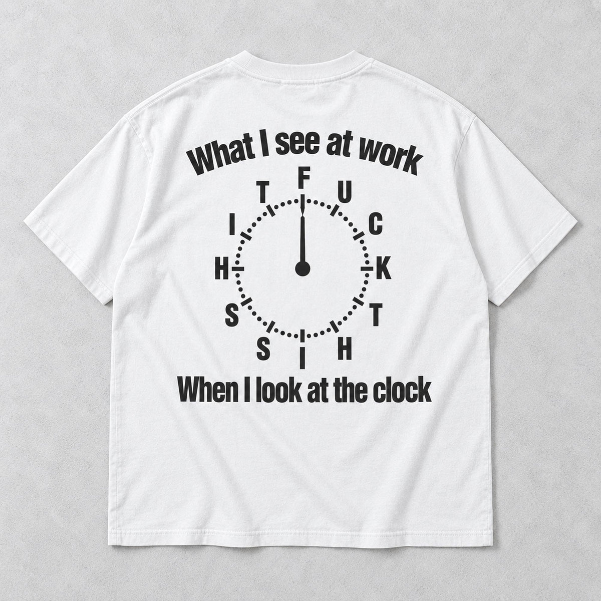 White graphic tee back flat lay with What I See At Work lettering design