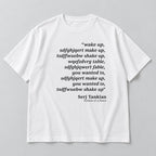 White tee front flat lay with Wake Up scrambled text and Serj Tankian attribution