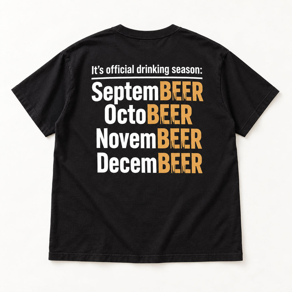 Official Drinking Season white and gold lettering on black T-shirt back flat lay, closer view