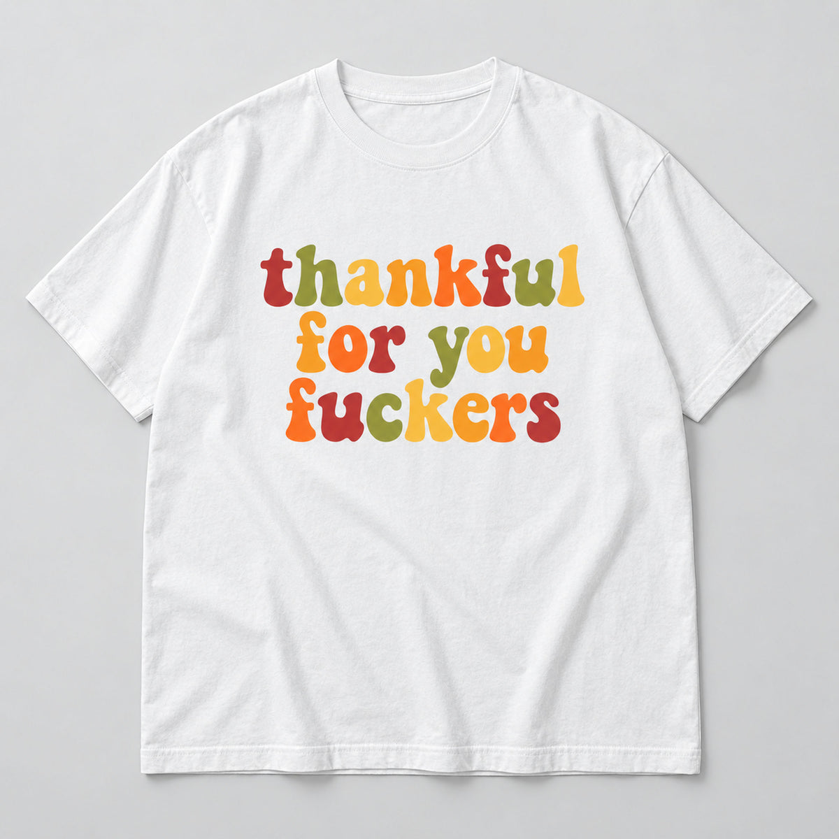 White tee front flat lay with colorful retro Thankful For You Fuckers lettering