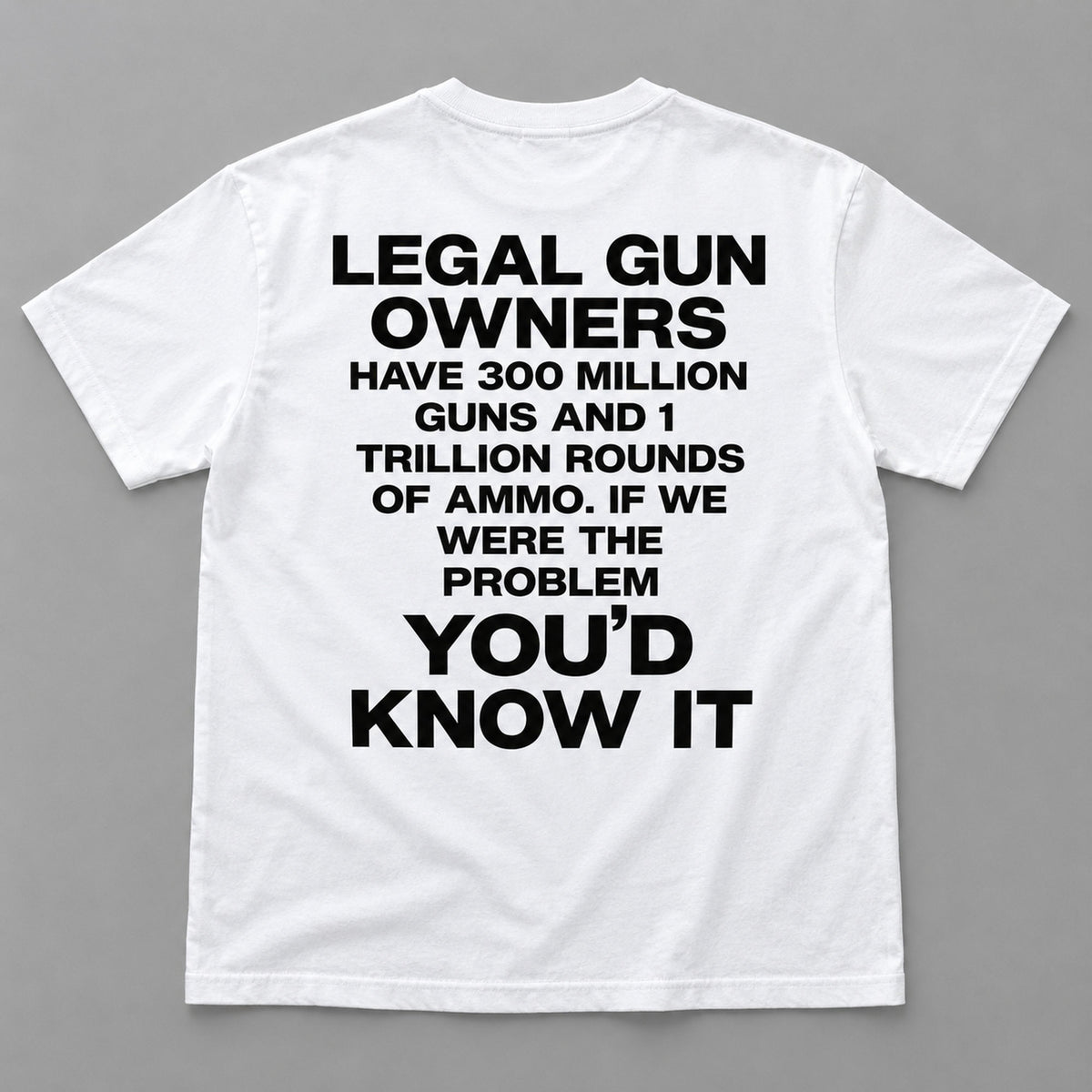 Legal Gun Owners statement back print on a white T-shirt, flat lay showing the complete lettering
