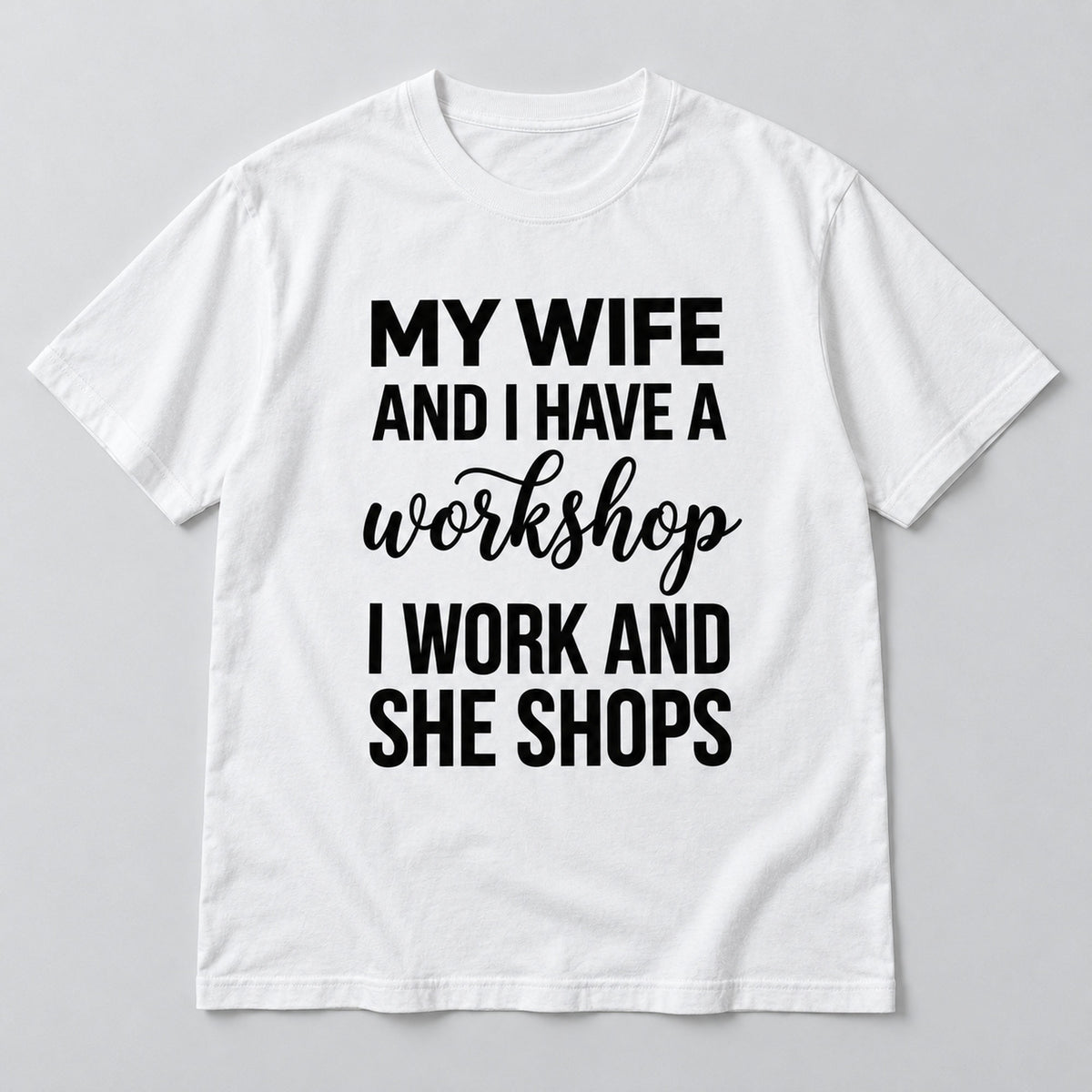 White graphic tee front flat lay with My Wife And I Have A Workshop design