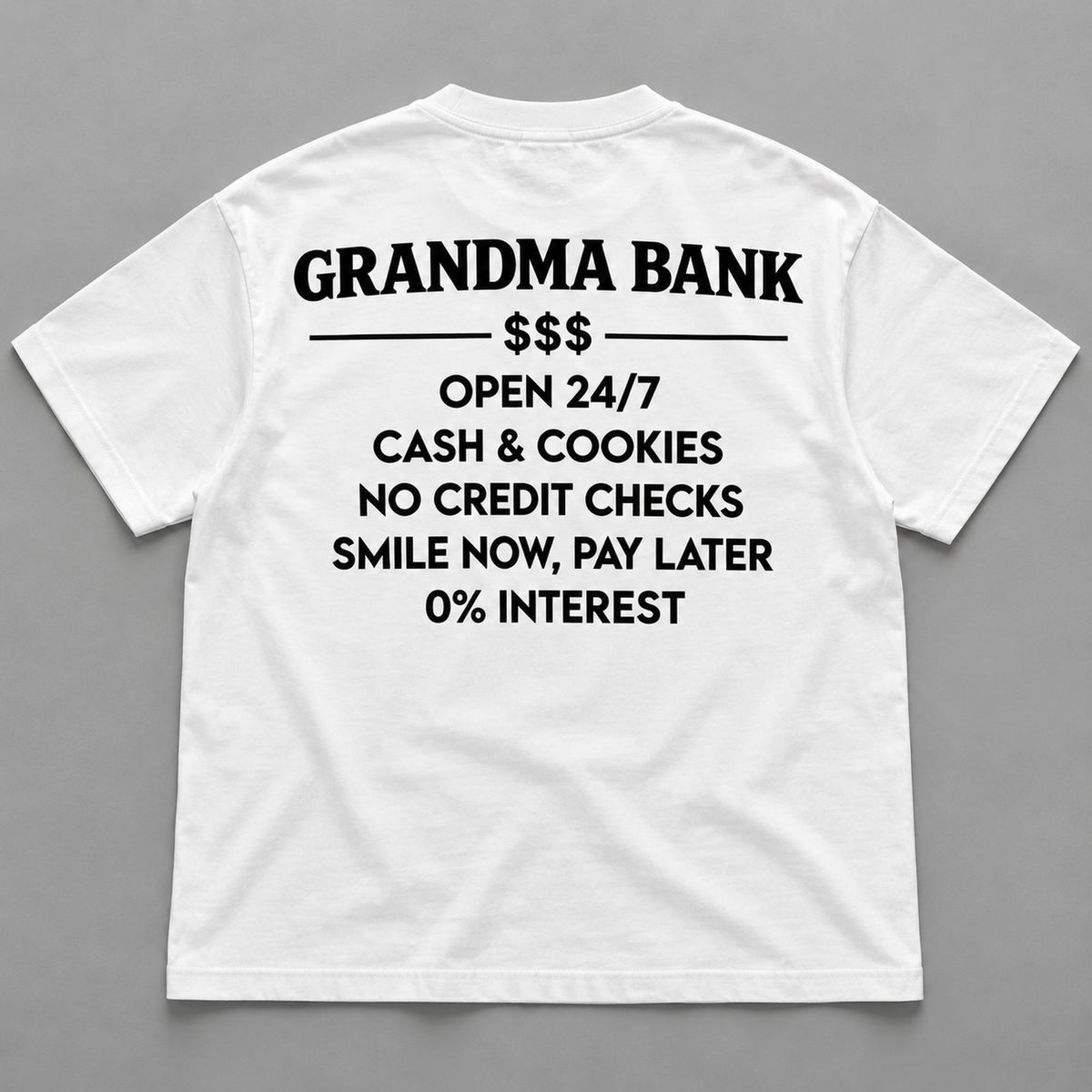 White graphic tee back flat lay with Grandma Bank lettering design
