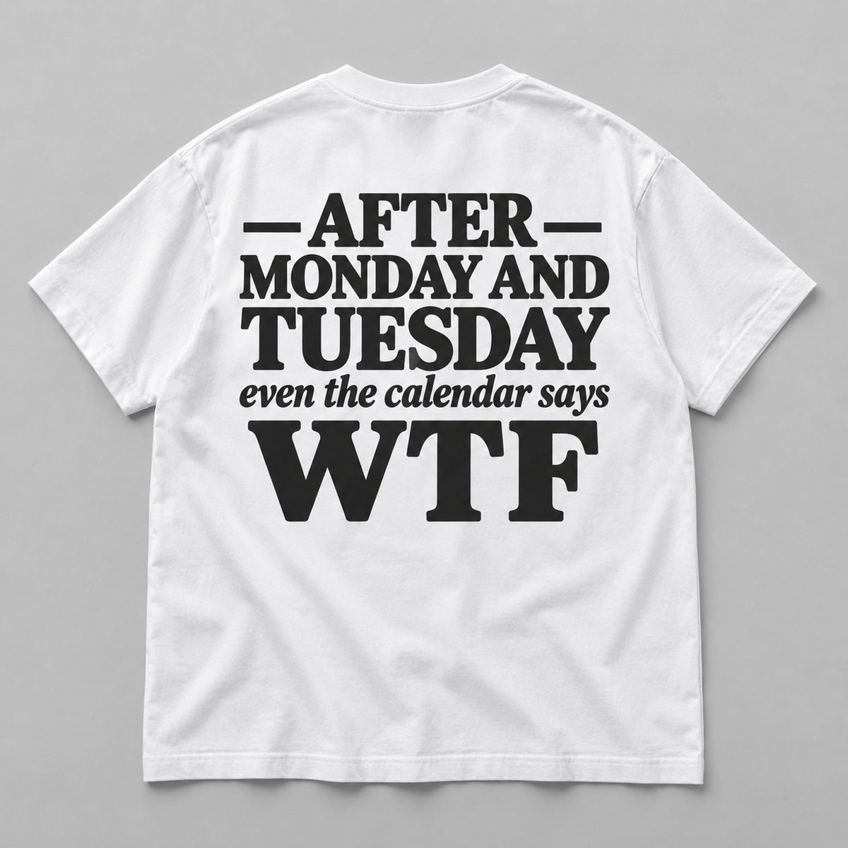 After Monday and Tuesday calendar WTF white back-print tee flat lay