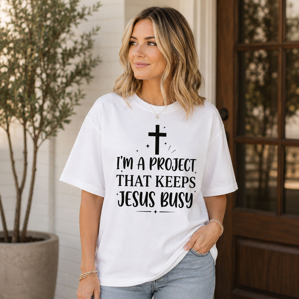 I'm A Project That Keeps Jesus Busy Faith Graphic Tee front print product photo 01 | Diya Glow