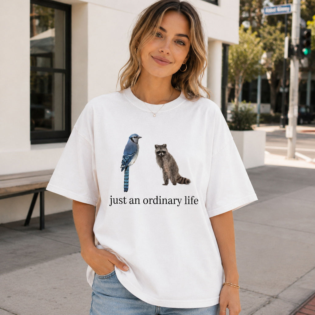 Just An Ordinary Life Blue Jay Raccoon Funny Graphic Tee front print product photo 01 | Diya Glow