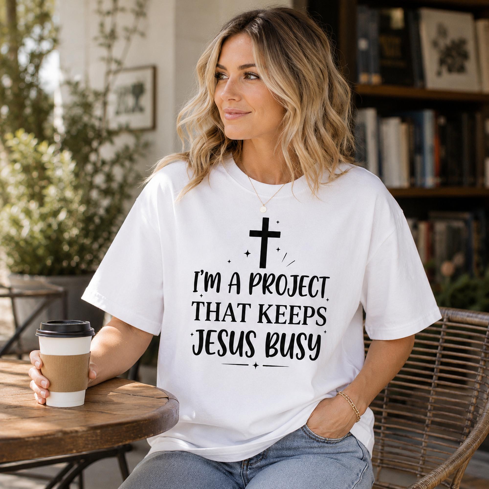 I'm A Project That Keeps Jesus Busy Faith Graphic Tee front print product photo 02 | Diya Glow