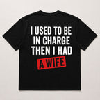 I Used To Be In Charge Then I Had A Wife funny graphic tee black back flat lay