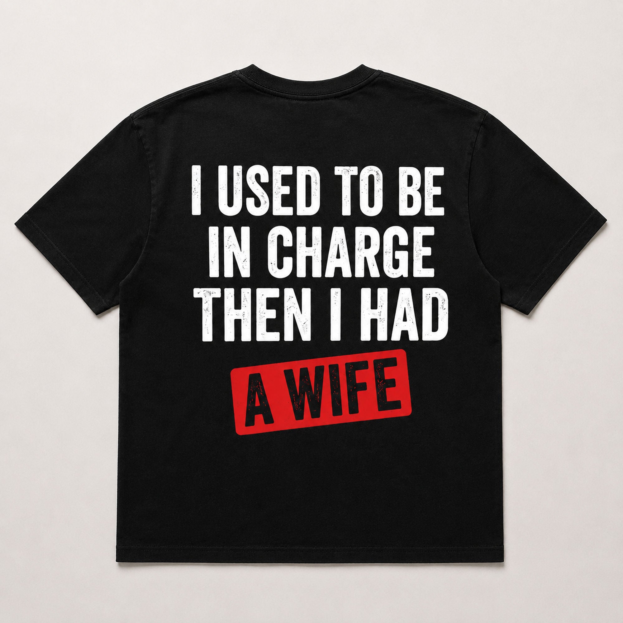 I Used To Be In Charge Then I Had A Wife funny graphic tee black back flat lay