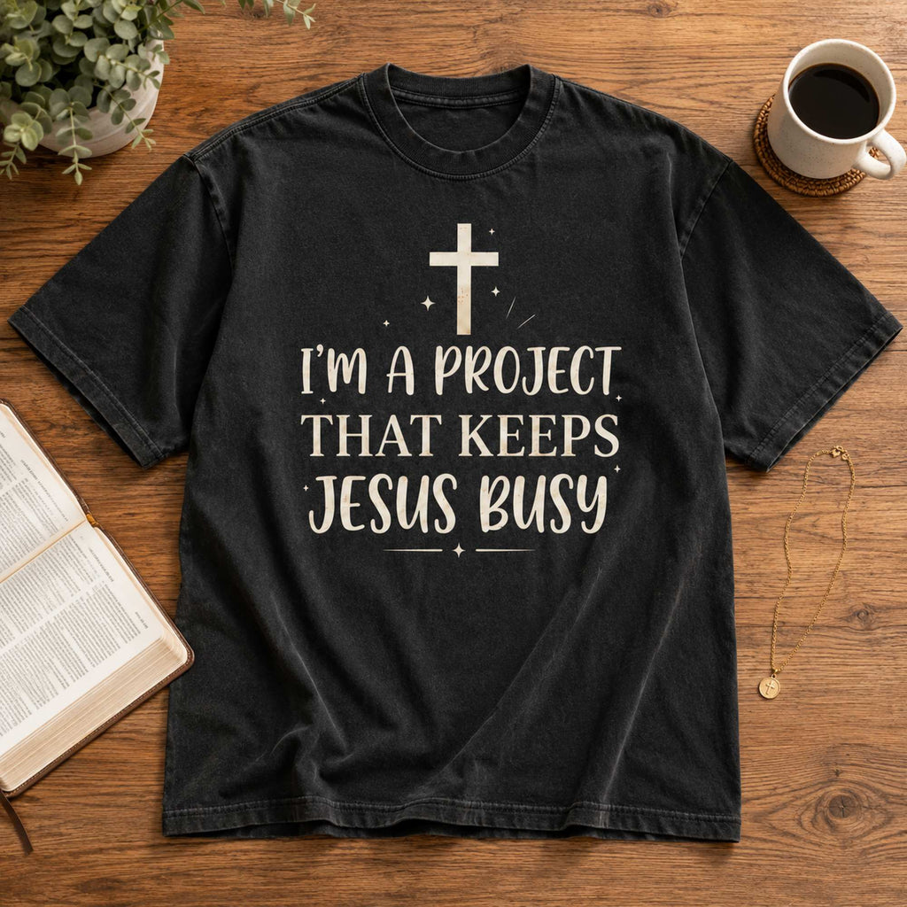 I'm A Project That Keeps Jesus Busy Faith Graphic Tee front print product photo 06 | Diya Glow