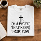 I'm A Project That Keeps Jesus Busy Faith Graphic Tee front print product photo 07 | Diya Glow