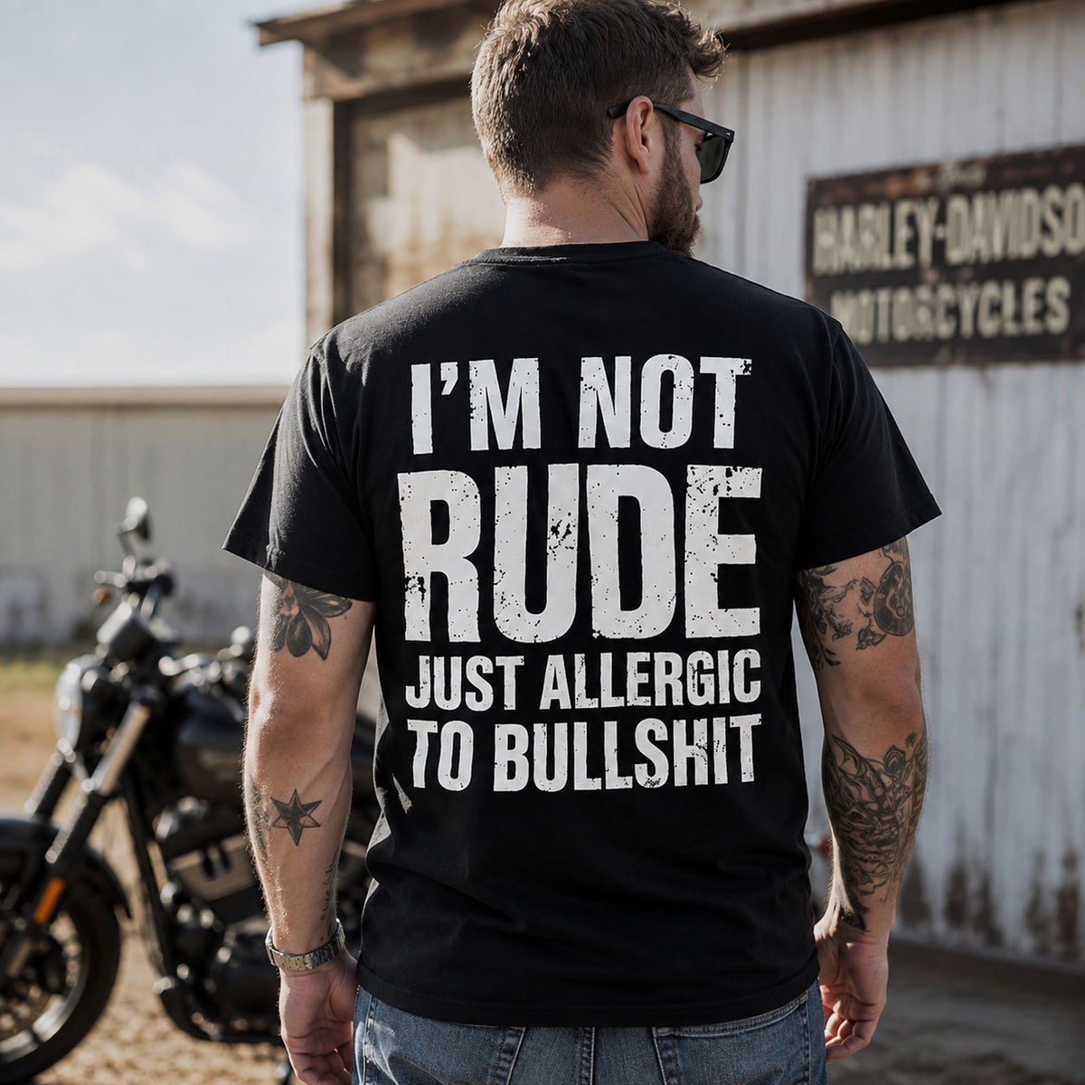 Man wearing black I'm Not Rude Just Allergic to Bullshit funny back-print graphic tee by a motorcycle