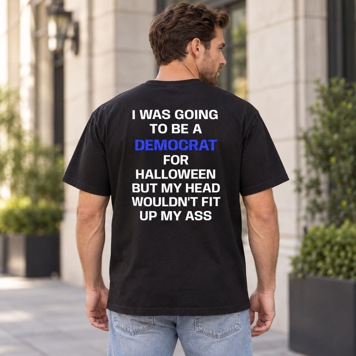 Democrat for Halloween blue-letter back-print graphic tee in black on a male model outdoors