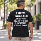 I Know I Swear A Lot funny graphic T-shirt in black with white back lettering, worn by a male model on an outdoor walkway