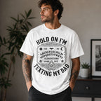 Male model wearing white Hold On I'm Texting My Dad Ouija board graphic tee, front view