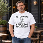Do I Look Like A Fucking People Person graphic tee white front print on male model at a pub patio