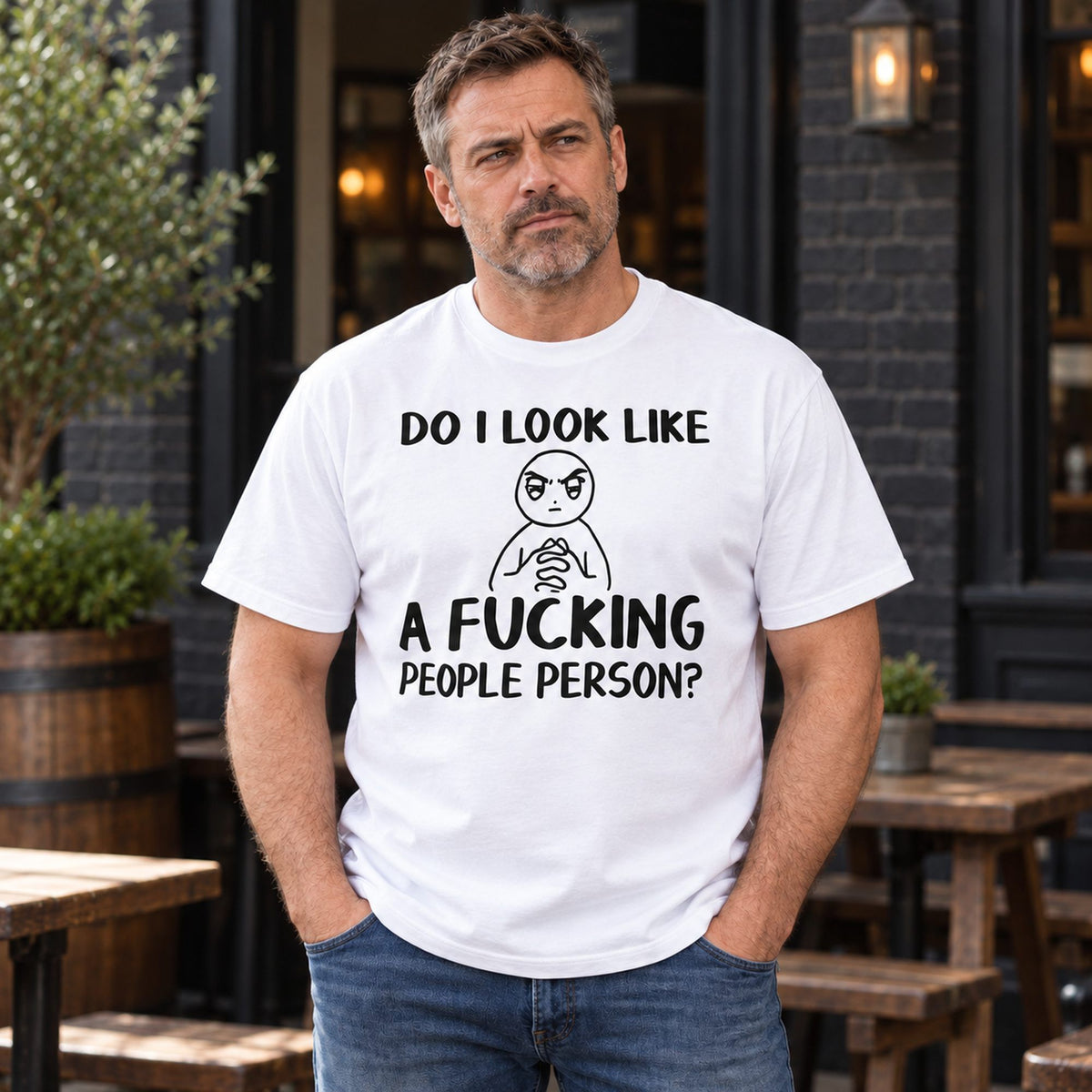 Do I Look Like A Fucking People Person graphic tee white front print on male model at a pub patio