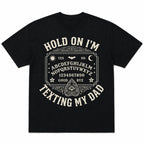 Black Hold On I'm Texting My Dad Ouija board graphic tee, front flat lay