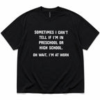 Black funny work graphic tee with white preschool-or-high-school slogan front flat lay