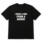Black I Need a Hug From a Baddie funny front-print graphic tee, front flat lay on white background
