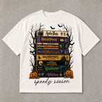 Spooky Season retro horror VHS stack graphic tee ivory front print flat lay