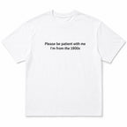 White Please Be Patient I'm From the 1900s funny front-print graphic tee flat lay on a white background