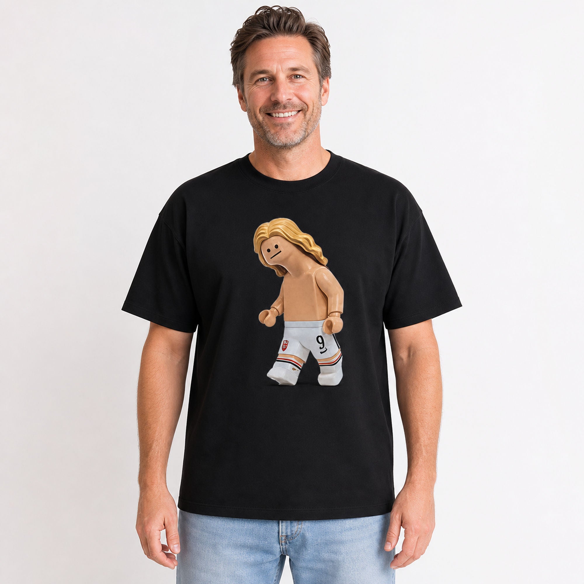 Blond number nine toy striker graphic on black T-shirt worn by a 40-year-old male lifestyle model